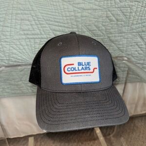 Black Mesh Trucker Hat with Blue Collars Logo